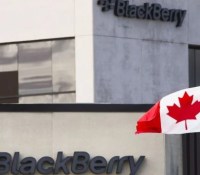 A Canadian flag waves in front of a Blackberry logo at the Blackberry campus in Waterloo