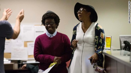 The room cheers for Shante Wolfe, left, and Tori Sisson, right after they are the first couple int the county to file their marriage license, Monday, Feb. 9, 2015, in Montgomery, Ala. Alabama began issuing marriage licenses to same-sex couples Monday despite an 11th-hour attempt from the state&#39;s chief justice to block the weddings. Alabama is the 37th state to allow gays and lesbians to wed.