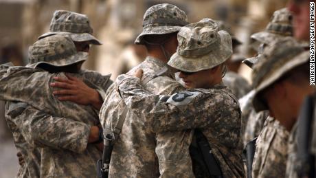 Colleagues of US army First Lieutenant Todd W. Weaver embrace during a memorial ceremony in his honor at Combat Outpost Terra Nova on the outskirts the Arghandab Valley&#39;s Jellawar village on September 14, 2010. 