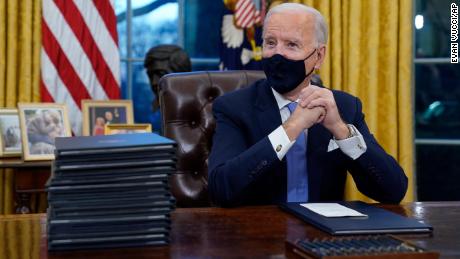 FILE - In this Jan. 20, 2021, file photo President Joe Biden waits to sign his first executive order in the Oval Office of the White House in Washington. As one of his first acts, Biden offered a sweeping immigration overhaul that would provide a path to U.S. citizenship for the estimated 11 million people who are in the United States illegally. It would also codify provisions wiping out some of President Donald Trump&#39;s signature hard-line policies, including trying to end existing, protected legal status for many immigrants brought to the U.S. as children and crackdowns on asylum rules. (AP Photo/Evan Vucci, File)