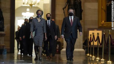 Clerk of the House Cheryl Johnson along with House Sergeant-at-Arms Tim Blodgett lead the Democratic House impeachment managers as they walk through Statuary Hall on Capitol Hill to deliver to the Senate the article of impeachment alleging incitement of insurrection against former President Donald Trump, in Washington, Monday, Jan. 25, 2021. (AP Photo/J. Scott Applewhite, Pool)