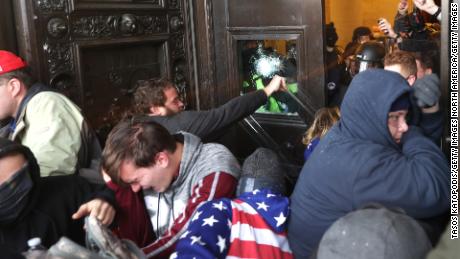 WASHINGTON, DC - JANUARY 06: Protesters gather on the door of the U.S. Capitol Building on January 06, 2021 in Washington, DC. Pro-Trump protesters entered the U.S. Capitol building after mass demonstrations in the nation&#39;s capital during a joint session Congress to ratify President-elect Joe Biden&#39;s 306-232 Electoral College win over President Donald Trump. (Photo by Tasos Katopodis/Getty Images)