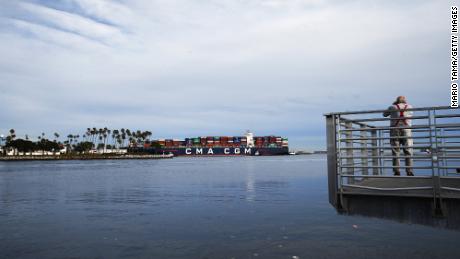 SAN PEDRO, CALIFORNIA - FEBRUARY 01: An onlooker takes photos as a container ship enters the Port of Los Angeles on February 1, 2021 in San Pedro, California. As of January 28, a record 38 container ships were on standby to offload cargo to the ports of Long Beach and Los Angeles amid a wave of online consumer goods purchases in the U.S. amid the pandemic. (Photo by Mario Tama/Getty Images)