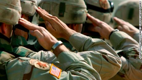 DUJAIL, IRAQ - OCTOBER 18:  U.S. Army soldiers salute during a memorial service for Sgt. Robert Tucker at a military base October 18, 2005 in Dujail, Iraq. Tucker, 20, from Cookeville, Tennessee, was killed by insurgents when a roadside bomb blew up his armored vehicle on October 13 near Dujail, just two weeks before the end of his 10-month deployment in Iraq. He was assigned to K-Troop, of the 278th Armored Cavalry Regiment, which patrols the area around Dujail. Saddam Hussein is scheduled to go on trial on October 19, for the death of 143 people from Dujail who he allegedly ordered killed in 1985 in revenge for an assassination attempt.  (Photo by John Moore/Getty Images)