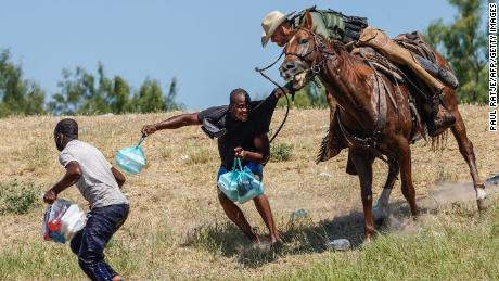 TOPSHOT - A United States Border Patrol agent on horseback tries to stop a Haitian migrant from entering an encampment on the banks of the Rio Grande near the Acuna Del Rio International Bridge in Del Rio, Texas on September 19, 2021. - The United States said Saturday it would ramp up deportation flights for thousands of migrants who flooded into the Texas border city of Del Rio, as authorities scramble to alleviate a burgeoning crisis for President Joe Biden&#39;s administration. (Photo by PAUL RATJE / AFP) (Photo by PAUL RATJE/AFP via Getty Images)