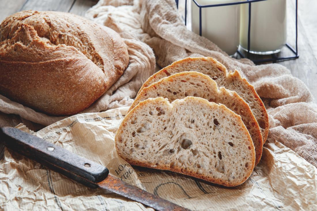 a loaf of bread and a knife on a table. 