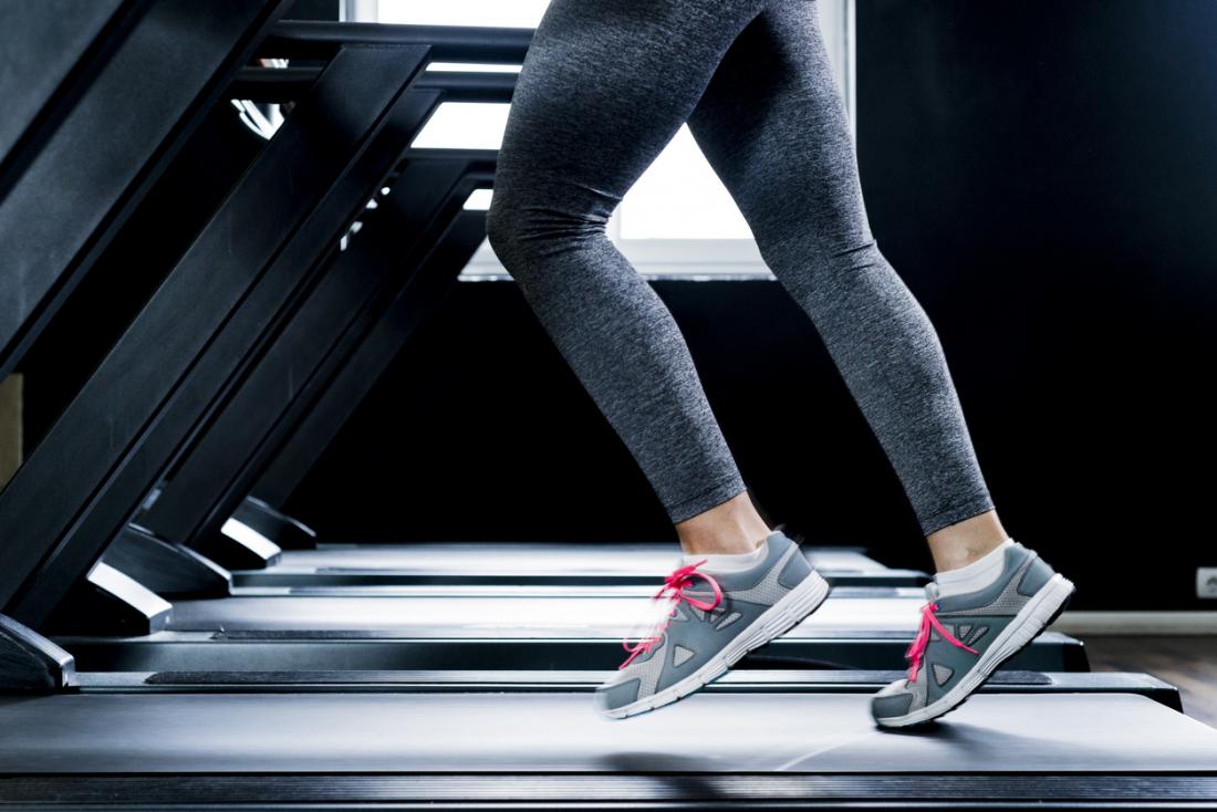 a woman running on a treadmill