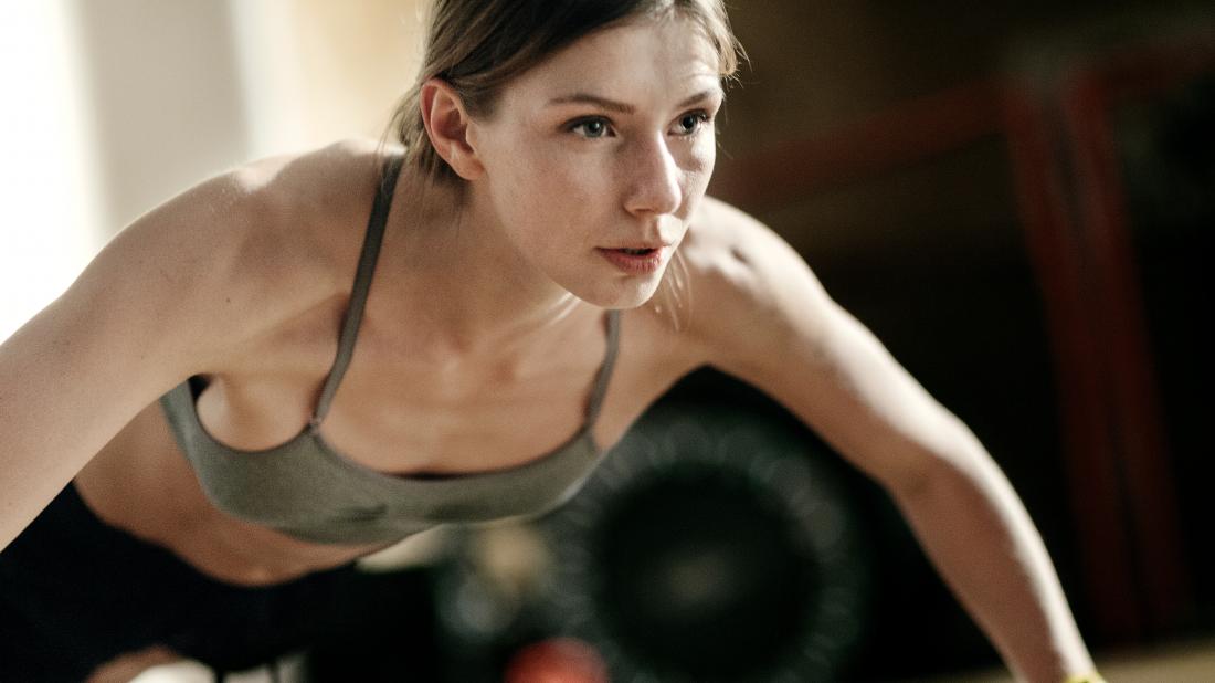 a woman doing pressups as part of her hiit workout and reaping all the benefits