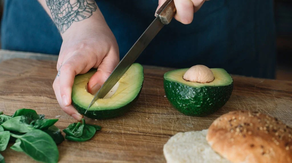 a man chopping a avocado