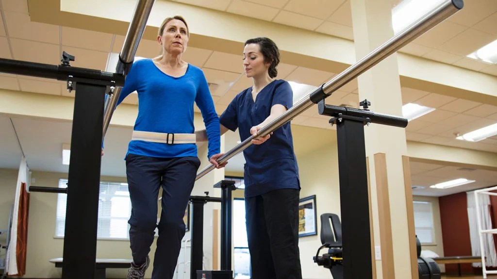 a woman having physical therapy as part of her spinal cord injury recovery plan