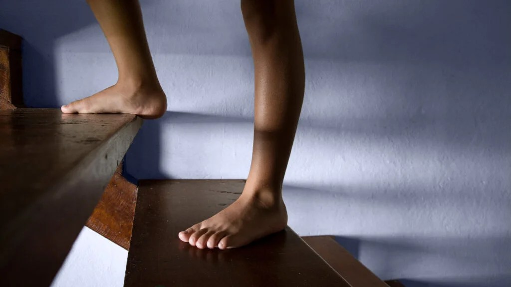 An image of a person's feet on stairs.