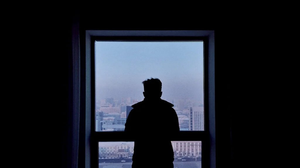 Silhouette of a male in a window