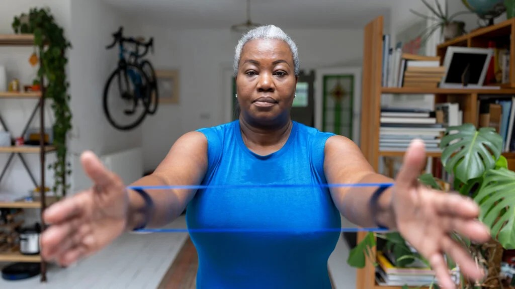 a woman is training with a resistance band