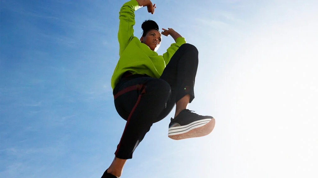A woman performing a jumping exercise.