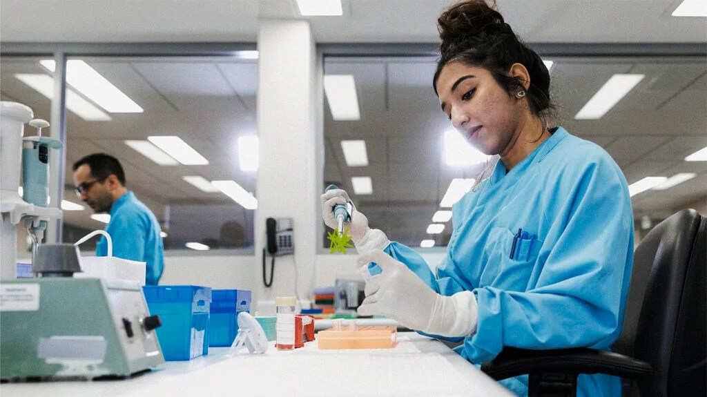 A lab technician is testing samples.