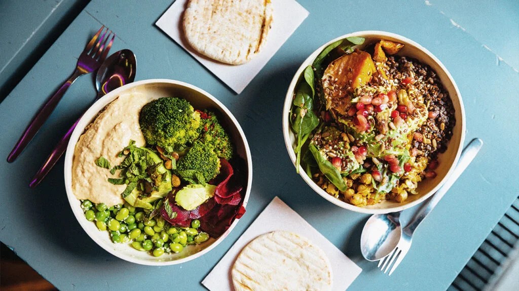 Vegan bowls with various vegetables and seeds, high angle view