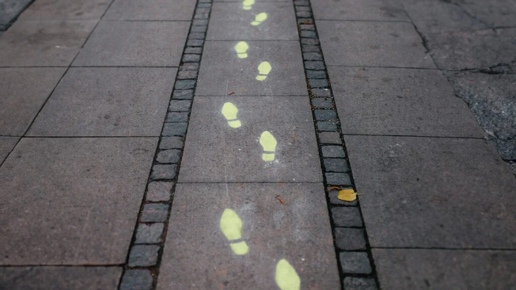 Painted footprints on a sidewalk.