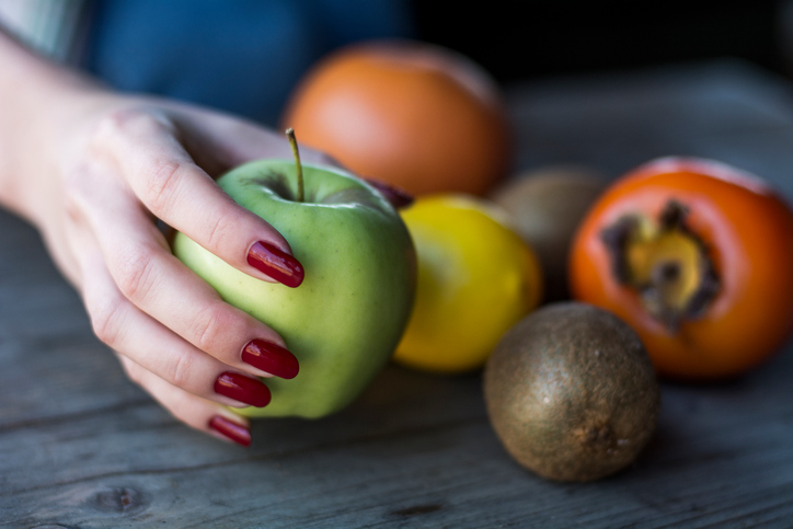 woman holding apple