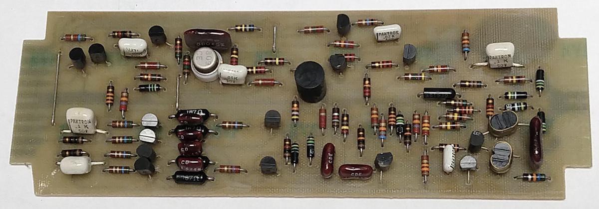 An op amp card. This card has a single input on the right. It uses a round metal-can op amp IC, but the chopper circuitry improves performance.