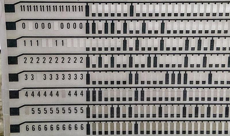 Detail of a CCROS sheet. It is programmed by punching holes in it with a keypunch.