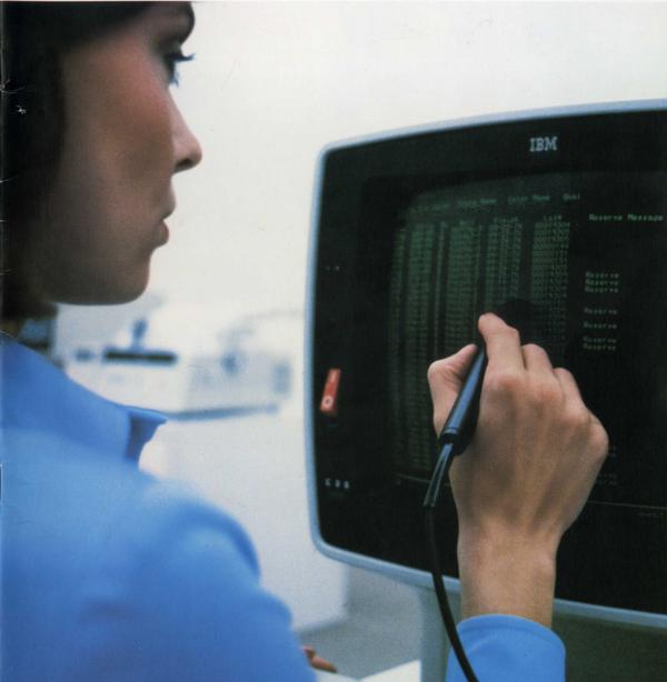 The IBM 3270 terminal. The Selector Light Pen was used to select data fields, somewhat like a mouse. This terminal is a later model, the 3278; in the photo it is displaying 43 lines of 80 characters. From IBM 3270 Brochure (1977).