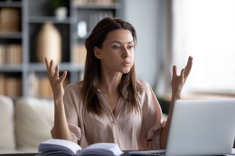 Woman CMO on laptop looking frustrated because her website's organic traffic has dropped