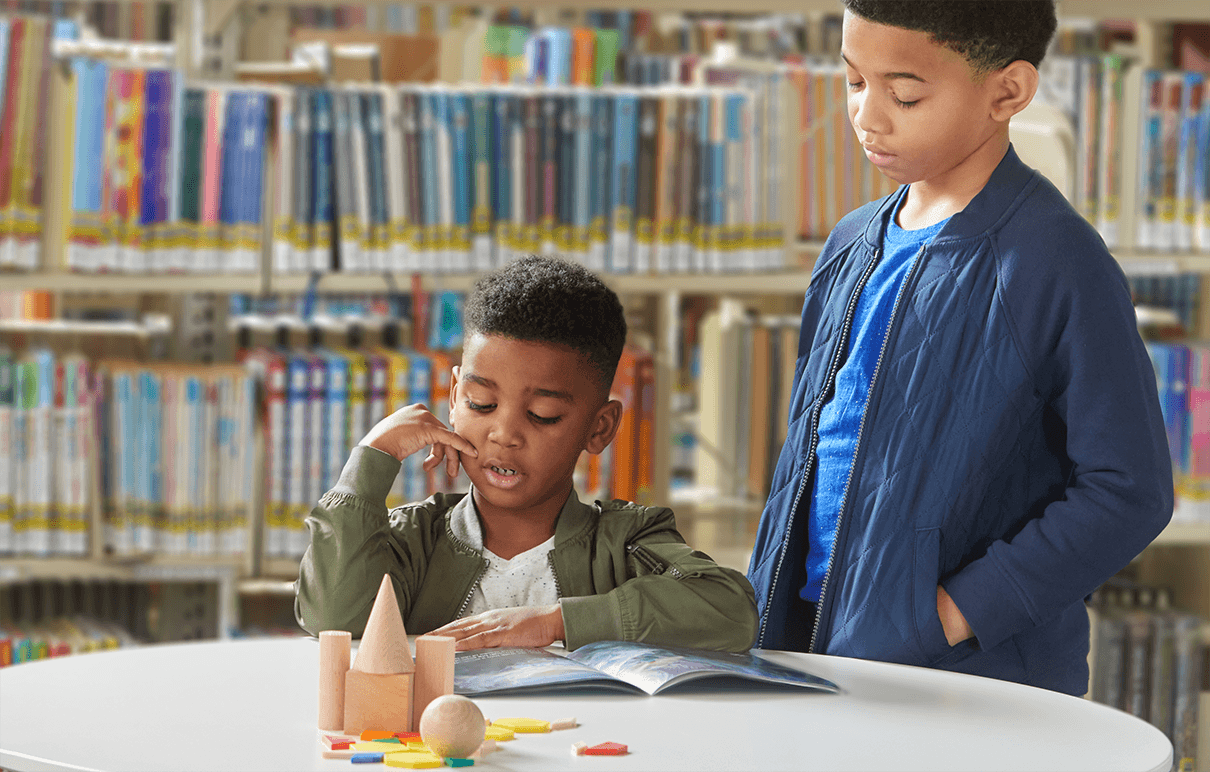 young boy reading geodes