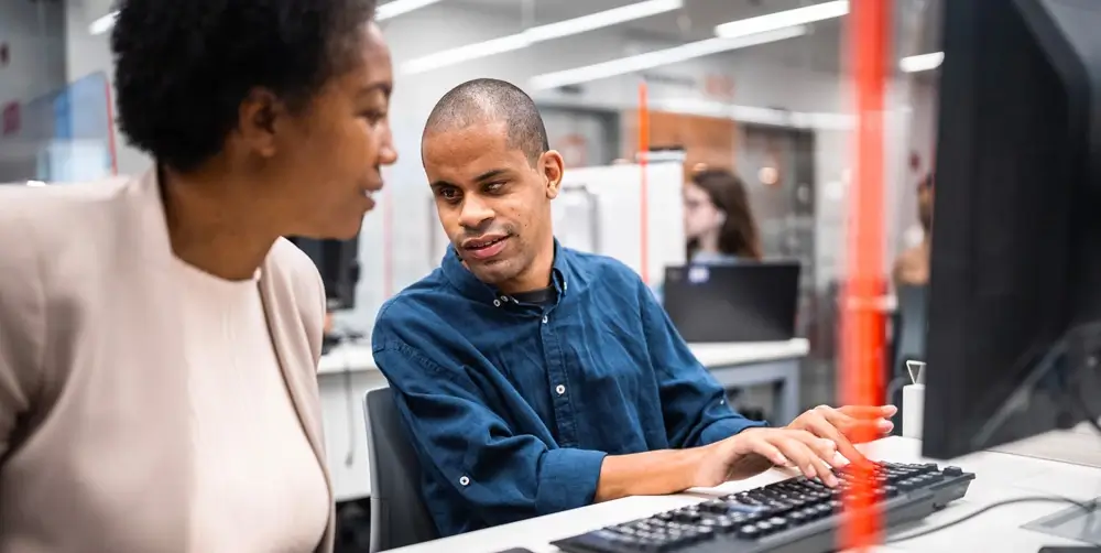 An employee training a new team member.