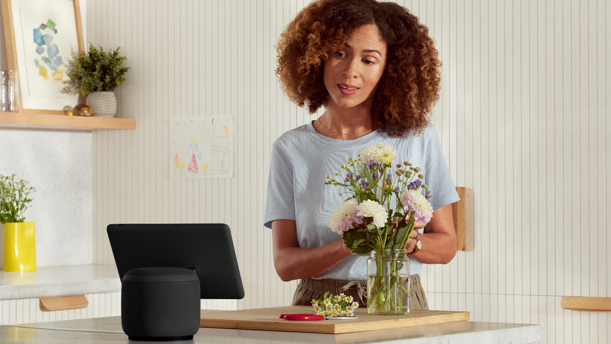 An image of a woman in her house interacting with Alexa through an Echo device. 