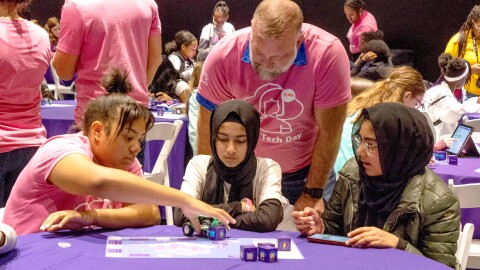 A photo of three girls working on a robotic car at an AWS Girls Tech Day in Ohio.