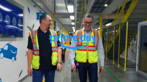 An Amazon employee walks alongside Amazon Stores CEO Doug Herrington