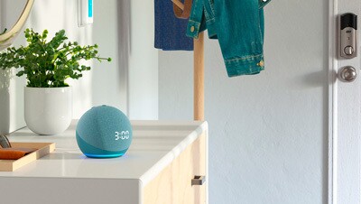 An image of an Amazon Echo device on a bedroom dresser. 