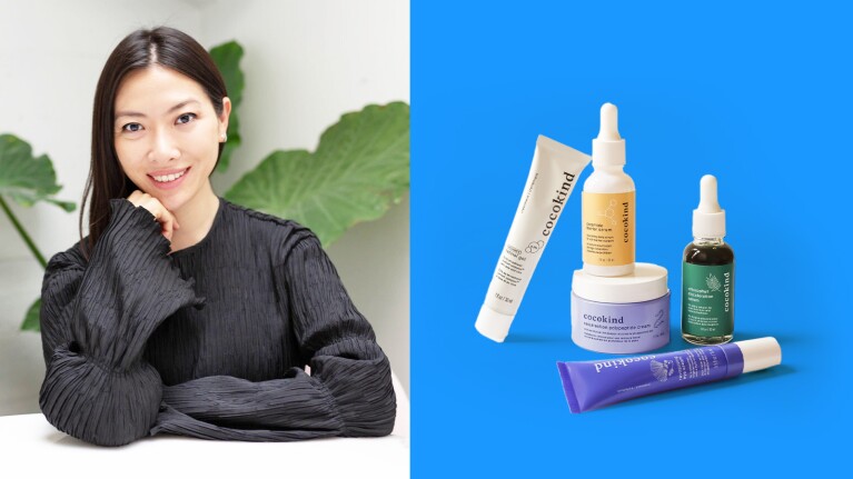 Smiling woman in black top next to skin care products