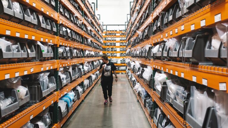 Worker walking through storage warehouse