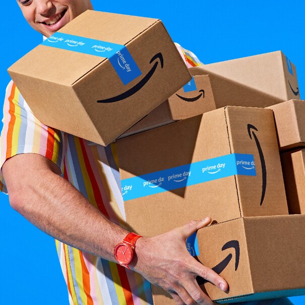 Prime Day 2023 live blog best deals: man holding a bunch of boxes.