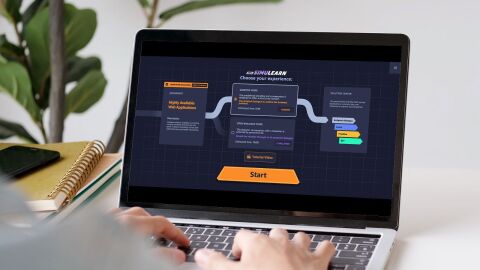 Hands typing on laptop keyboard displaying SimuLearn