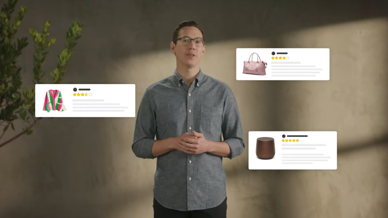 A man wearing a collared grey button up shirt stands up with three pop outs of Amazon products around him.