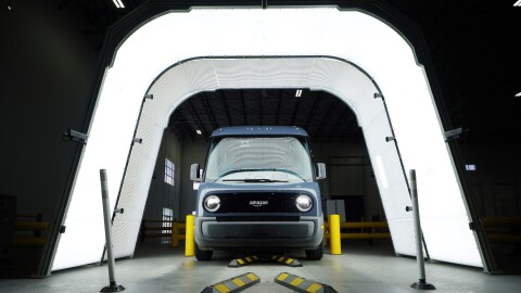 An image of an Amazon delivery van receiving a full-vehicle scan