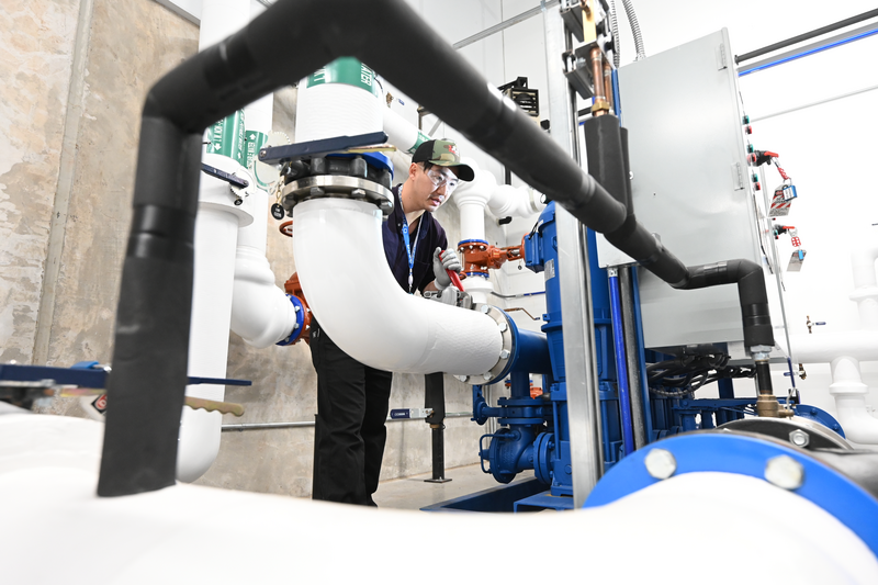 A person working on water pipes.