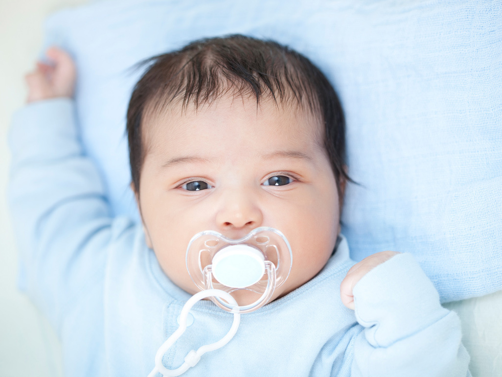 Baby using a dummy