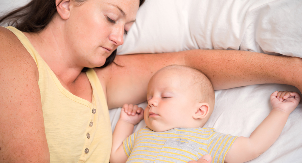 Mum and baby co-sleeping.