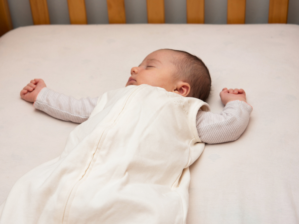 Baby asleep in cot