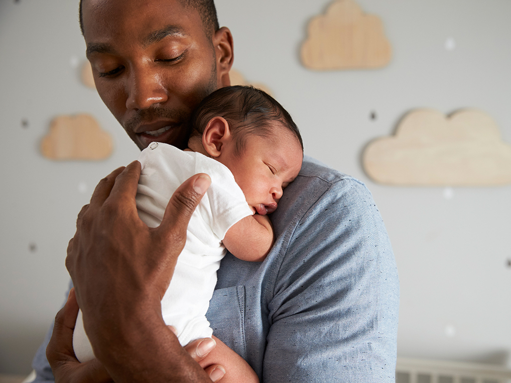 Baby sleeping on father's shoulder 