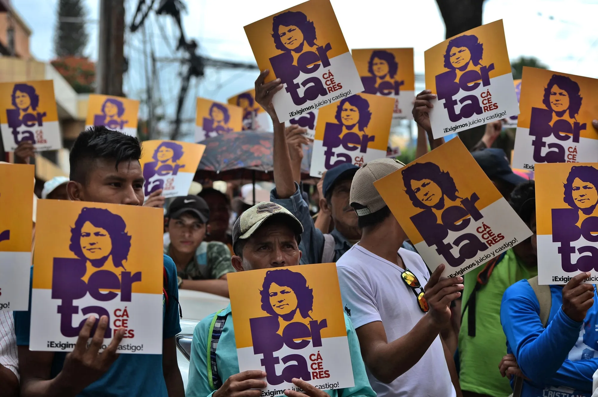 Members of the Council of Popular and Indigenous Organizations of Honduras hold posters with an image of slain indigenous leader and environmental activist Berta Cáceres in Tegucigalpa on Oct. 10, 2019.