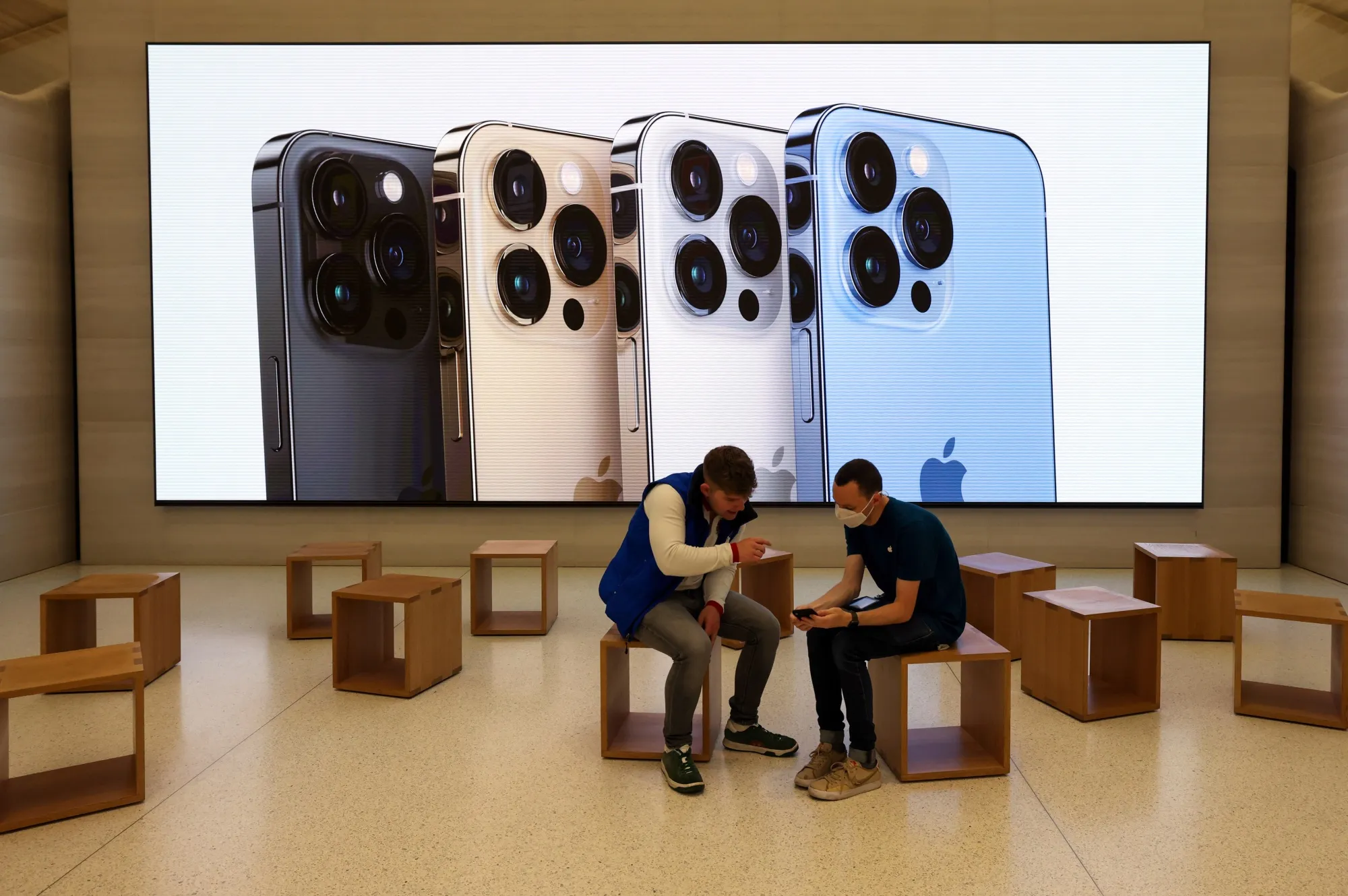 An employee serves a customer in the Apple store on Regent Street in London&nbsp;on Sept. 24.&nbsp;