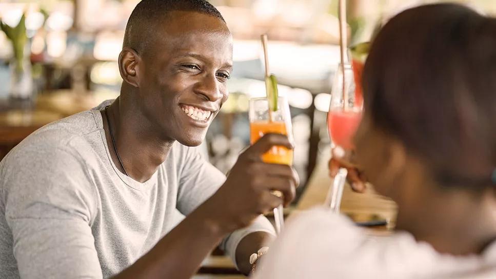 Couple enjoying mixed drinks during the day in a bar