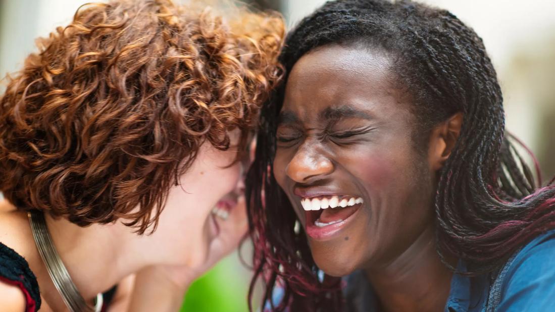 Two friends laughing together