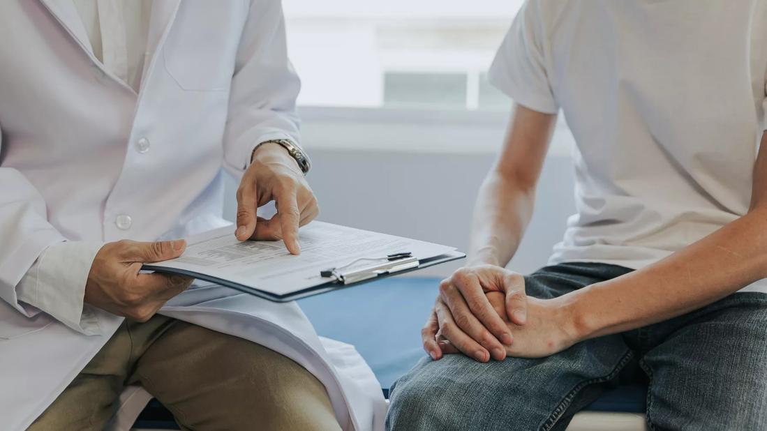 Healthcare provider discussing lab results with a younger man