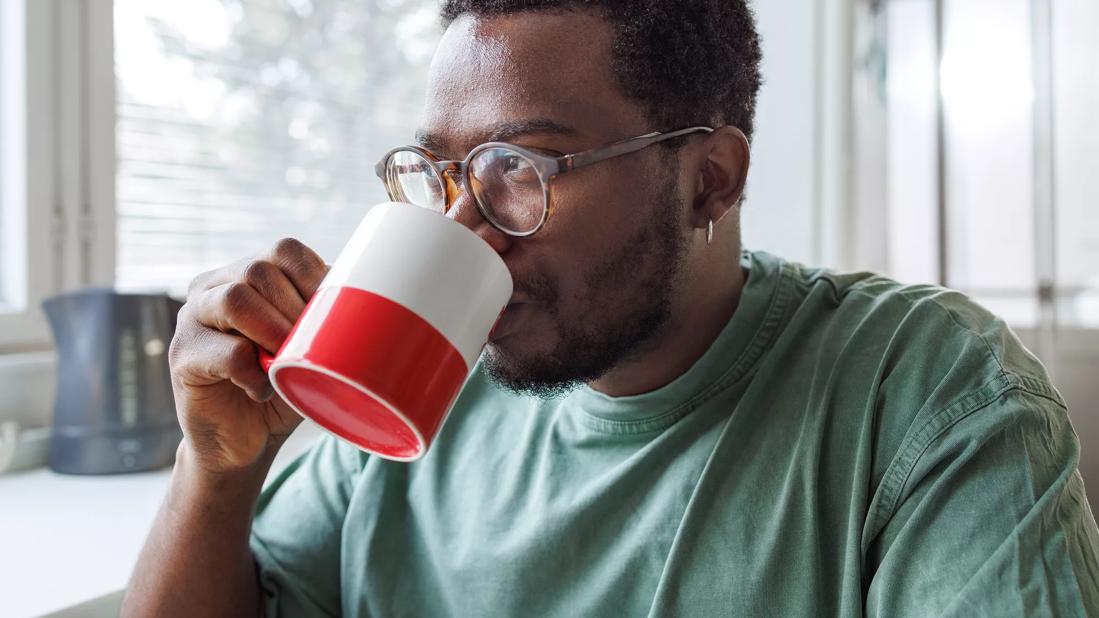 Person drinking from a coffee mug