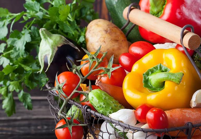 Variety of vegetables including a yellow bell pepper, tomatoes and eggplant.